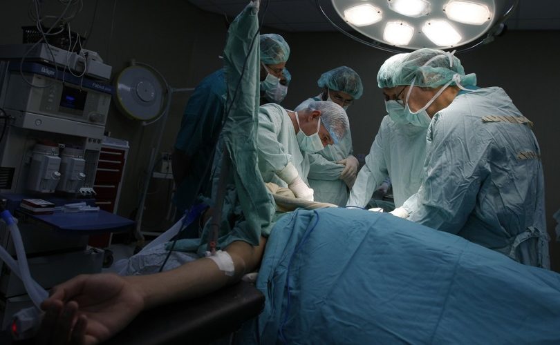 British doctor Christophe Bulstrode (C) and Palestinian surgeons from the Gaza Strip perform a surgery on a patient at Nasser Hospital in Khan Yunis, southern Gaza, on December 15, 2009. French medical non governmental organization Medecins du Monde, led by senior surgeon Dr. Bulstrode arrived in Gaza for an one-week training session, aiming at upgrading the knowledge of some ten orthopedic surgeons from Gaza in the field of war and trauma orthopedic medicine. AFP PHOTO/ SAID KHATIB (Photo credit should read SAID KHATIB/AFP/Getty Images)
