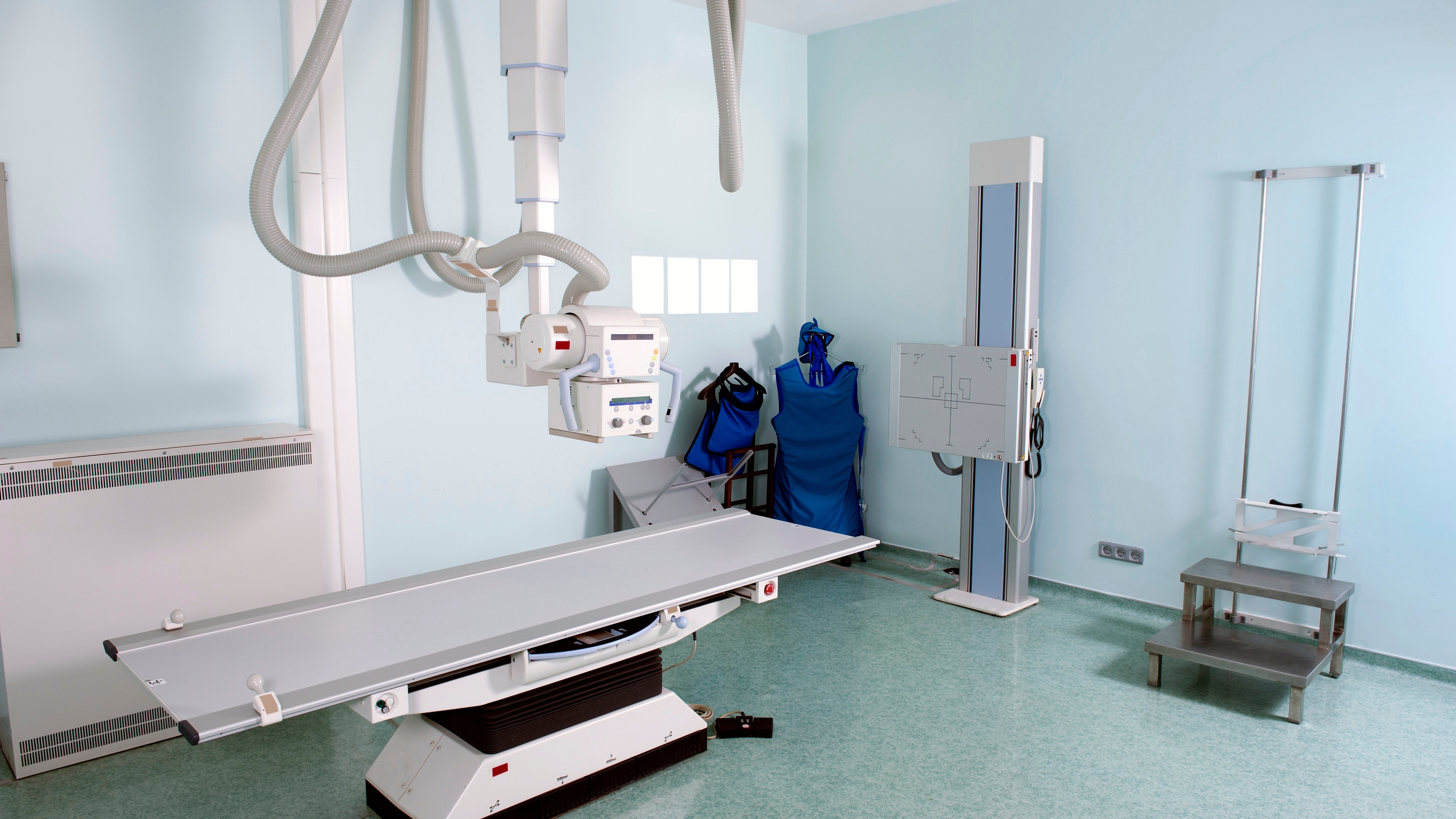 X-Ray machine and patient table at Shah Hospital imaging suite.